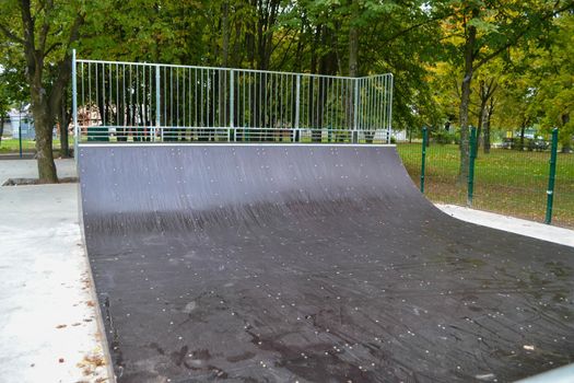 skatepark ramps in the park on autumn. High quality photo