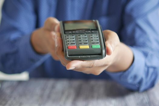 hand holding pos machine close up