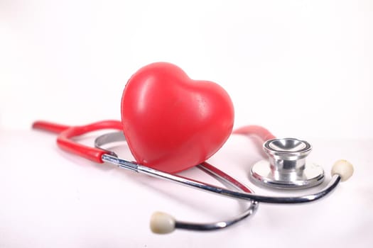 heart shape symbol and stethoscope on white background.