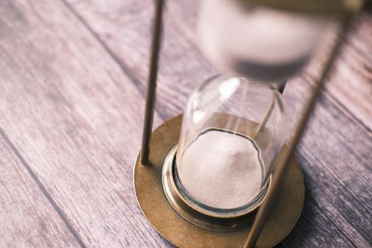 hourglass on table, Sand flowing through the bulb of Sandglass.