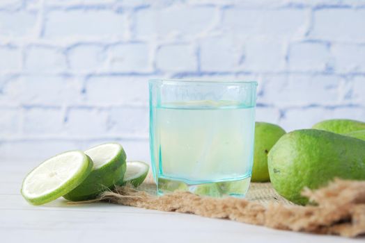 Refreshing lemon water drink on table , top view .