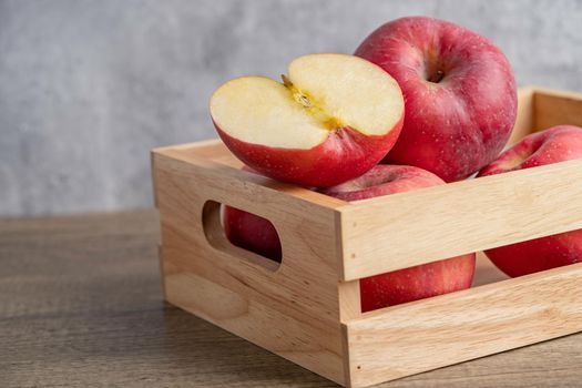 Apple and half fruit in wooden box with copy space.