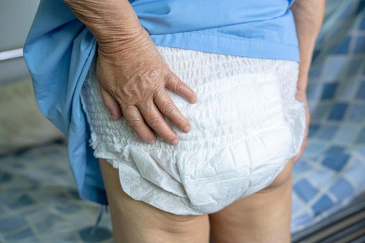 Asian senior or elderly old lady woman patient wearing incontinence diaper in nursing hospital ward, healthy strong medical concept.