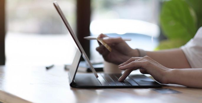 Woman using laptop with calculator and credit card on table, Online shopping.