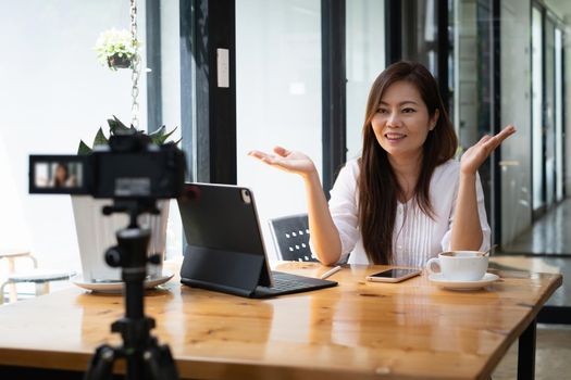 Business woman or blogger recording vlog on digital camera and live stream