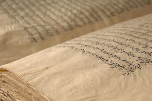 Tashkent, Uzbekistan - August 10, 2009: Ancient open book in arabic. Old arabic manuscripts and texts