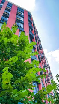 Fragment of new residential complex with buildings exterior, luxury house and home complex on blue sky background. Modern neighborhood concept.