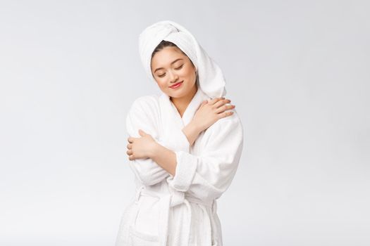 Spa skincare beauty Asian woman drying hair with towel on head after shower treatment. Beautiful multiracial young girl touching soft skin.