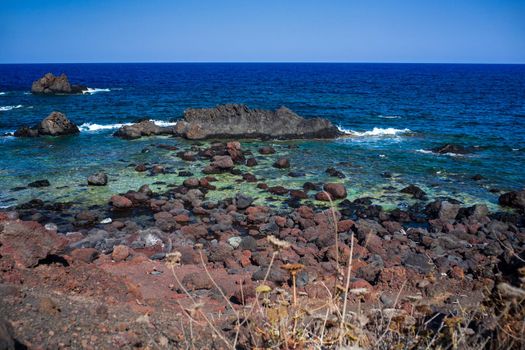 View of the lava beach of Linosa Called Faraglioni, Sicily. Italy