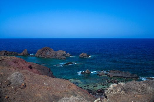 View of the lava beach of Linosa Called Faraglioni, Sicily. Italy