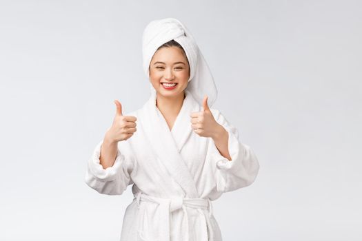 Beautiful asian woman perfect skin showing thumbs up isolated on white background