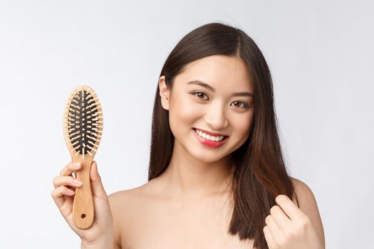 portrait of a beautiful young woman comb wonderful hair isolated on white background, asian beauty.