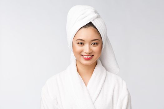 Spa skincare beauty Asian woman drying hair with towel on head after shower treatment. Beautiful multiracial young girl touching soft skin