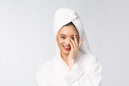 Spa skincare beauty Asian woman drying hair with towel on head after shower treatment. Beautiful multiracial young girl touching soft skin.