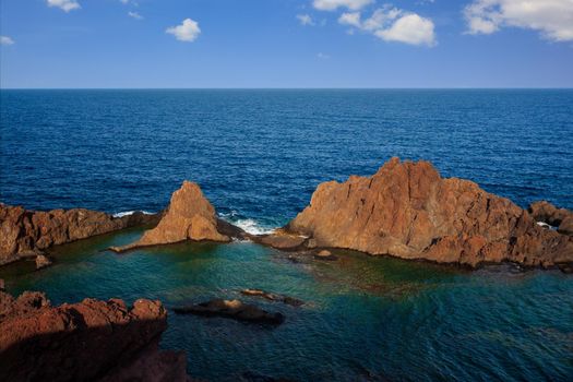 View of the lava beach of Linosa Called Faraglioni, Sicily. Italy