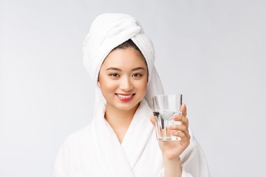 Healthy young beautiful woman drinking water, beauty face natural makeup, isolated over white background