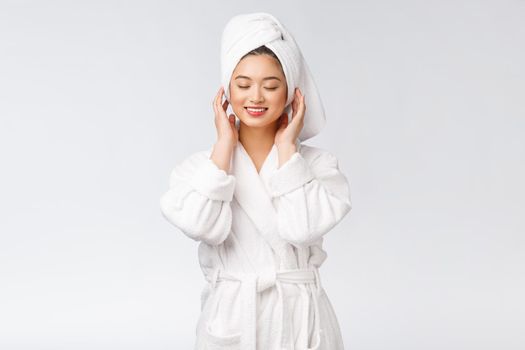 Portrait of a young happy asian lady in bathrobe.Isolated in white background