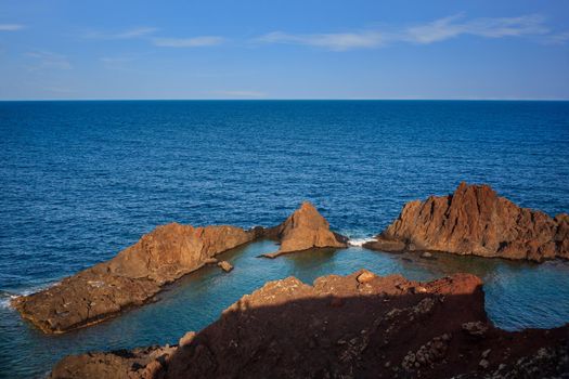 View of the lava beach of Linosa Called Faraglioni, Sicily. Italy