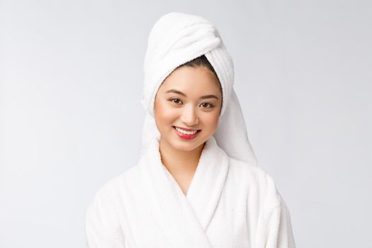 Portrait of a young happy asian lady in bathrobe.Isolated in white background