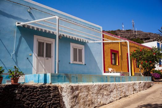 View of a typical colorful houses in the street of Linosa, Sicily. Italy