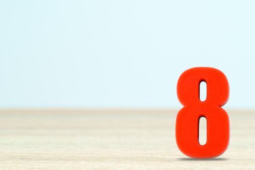 Shot of a number eight made of red plastic on table with copy space