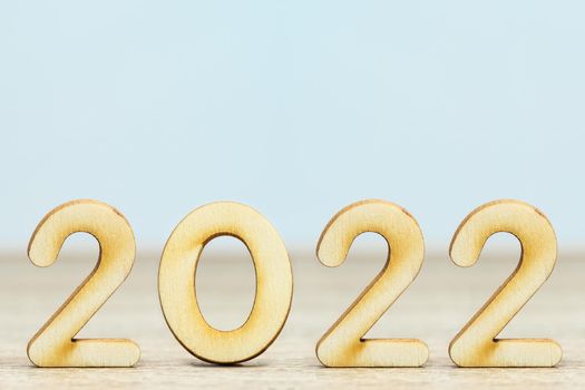 Close up wooden numeric new year 2022 on table with copy space