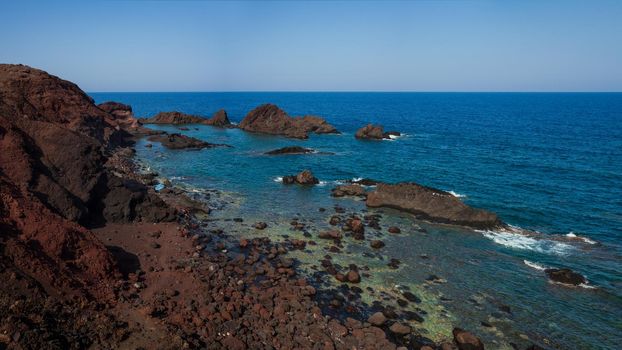 View of the lava beach of Linosa Called Faraglioni, Sicily. Italy