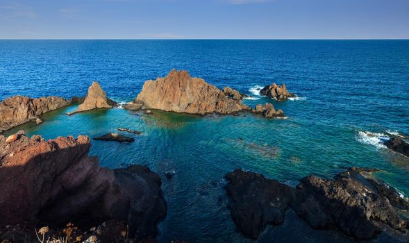 View of the lava beach of Linosa Called Faraglioni, Sicily. Italy