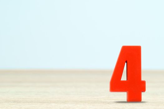 Shot of a number four made of red plastic on table with copy space