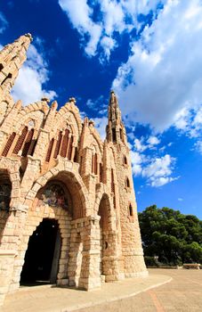 Novelda, Alicante, Spain- September 24, 2021: Details, archs, tower and pictures of Sanctuary of Santa Maria Magdalena on the top of the mountain in Novelda, Alicante, Spain.