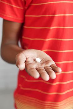 close up of medical pills on palm of child hand ,