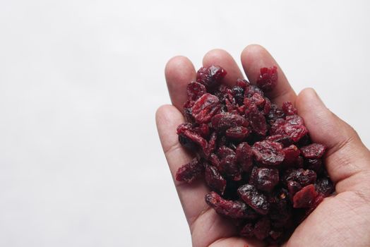 dried cranberries on hand with copy space .