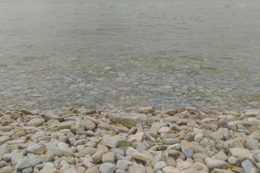 The coast of the sea or ocean with stones and clear water