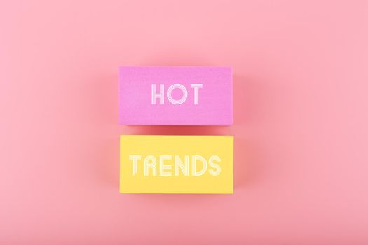 Hot trends written on colorful rectangles on light pink background. Concept of newest, latest, hot and popular trends of 2022