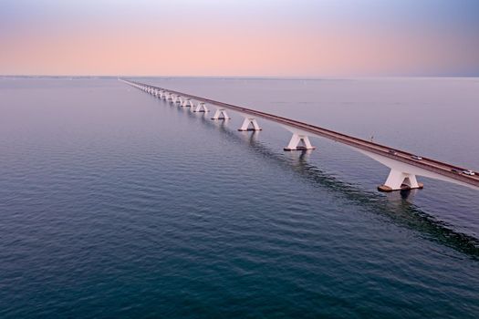 Aerial view on the longest bridge in the Netherlands, Zealand bridge spans Eastern Scheldt estuary, connects islands Schouwen-Duiveland and Noord-Beveland in province of Zeeland, water of Oesterschelde in the Netherlands