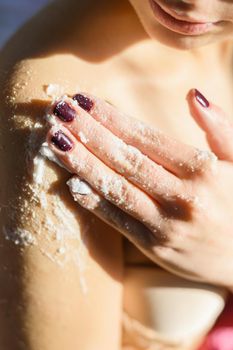woman applying body scrub her shoulder. Resolution and high quality beautiful photo