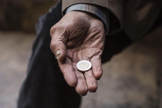 homeless man holding coin his hand. Resolution and high quality beautiful photo
