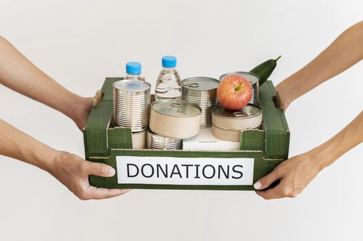 hands holding donation box with provisions. Resolution and high quality beautiful photo