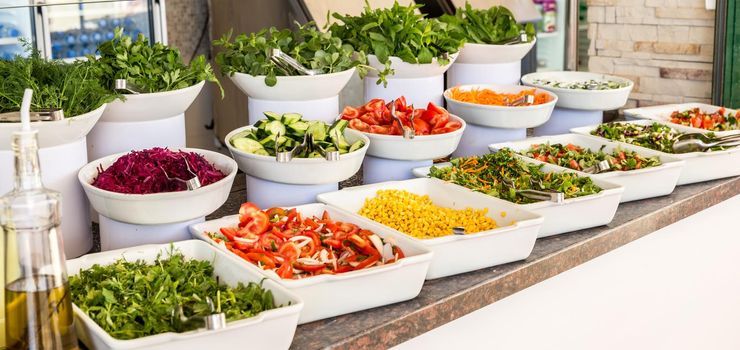 Variety of fresh salads in a buffet. Concept of all inclusive hotel and healthy eating