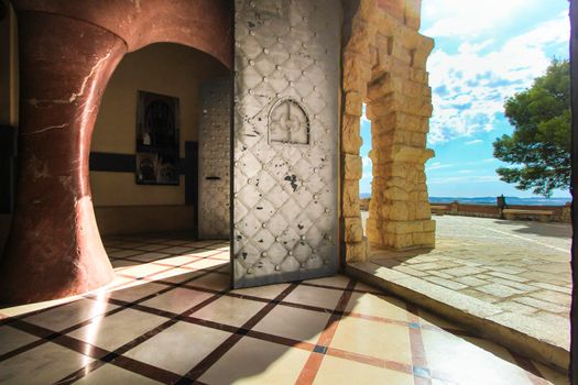 Novelda, Alicante, Spain- September 24, 2021: Details, archs, tower and pictures of Sanctuary of Santa Maria Magdalena on the top of the mountain in Novelda, Alicante, Spain.