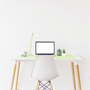 laptop with blank white screen desk front wall. Resolution and high quality beautiful photo
