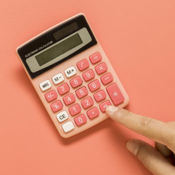 hand with pink calculator colored surface. Resolution and high quality beautiful photo