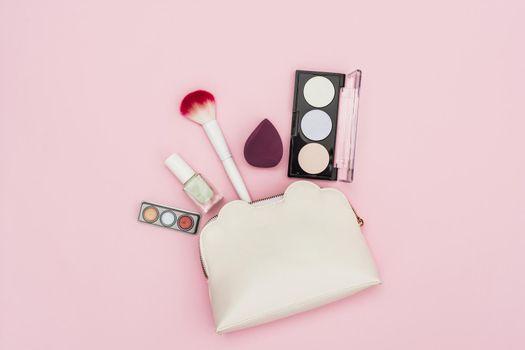 eyeshadow palette nail polish bottle blender makeup brush makeup bag pink background. Resolution and high quality beautiful photo