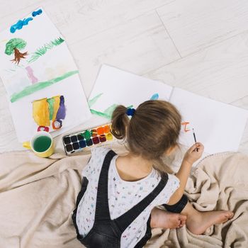 little girl painting with aquarelle floor. Resolution and high quality beautiful photo