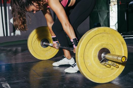woman with yellow barbell gym. Resolution and high quality beautiful photo