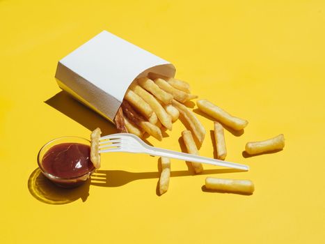 french fries with ketchup plastic fork. Resolution and high quality beautiful photo