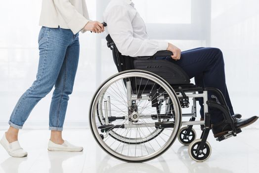 low section woman pushing man sitting wheelchair. Resolution and high quality beautiful photo