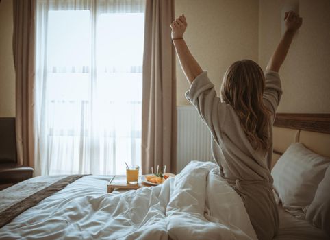 rear view woman stretching body after awakening bed. Resolution and high quality beautiful photo