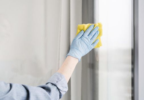 woman with rubber glove wiping window. Resolution and high quality beautiful photo