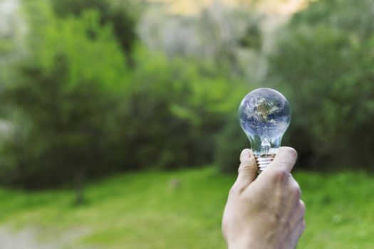 male hand holding earth glass bulb. Resolution and high quality beautiful photo